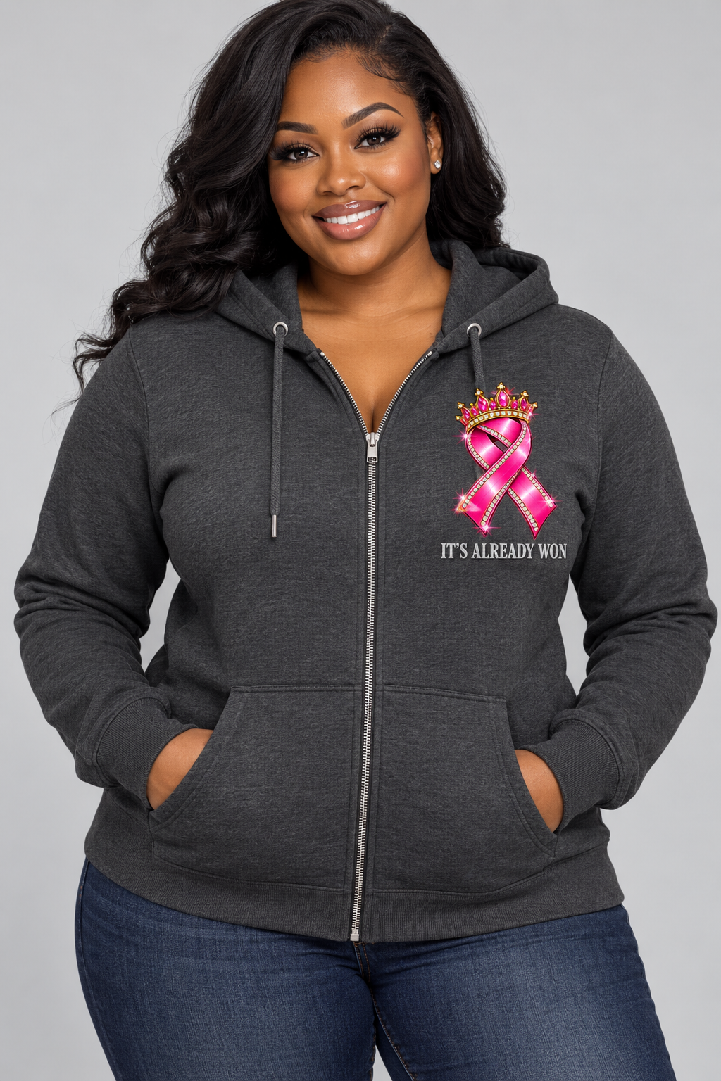 Front of charcoal zip hoodie with crowned pink ribbon and It's Already Won chest design